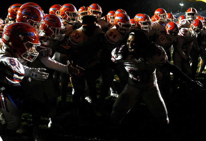 Olentangy Orange's Eli Payne celebrates with teammates after the Pioneers defeated Olentangy Liberty, 17-3.  (Shane Flanigan / ThisWeek Community News)